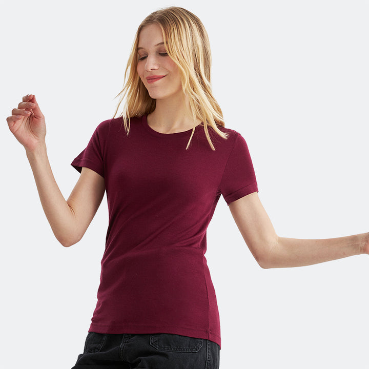 Famel model wearing a lightweight Merino wool short sleeve crew t-shirt, breathable and comfortable, shown in dark red.