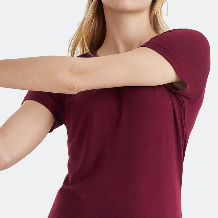 Famel model wearing a lightweight Merino wool short sleeve crew t-shirt, breathable and comfortable, shown in dark red.