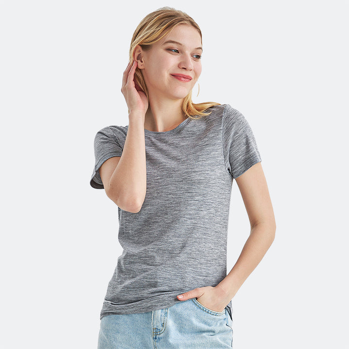 Famel model wearing a lightweight Merino wool short sleeve crew t-shirt, breathable and comfortable, shown in ebony heather.