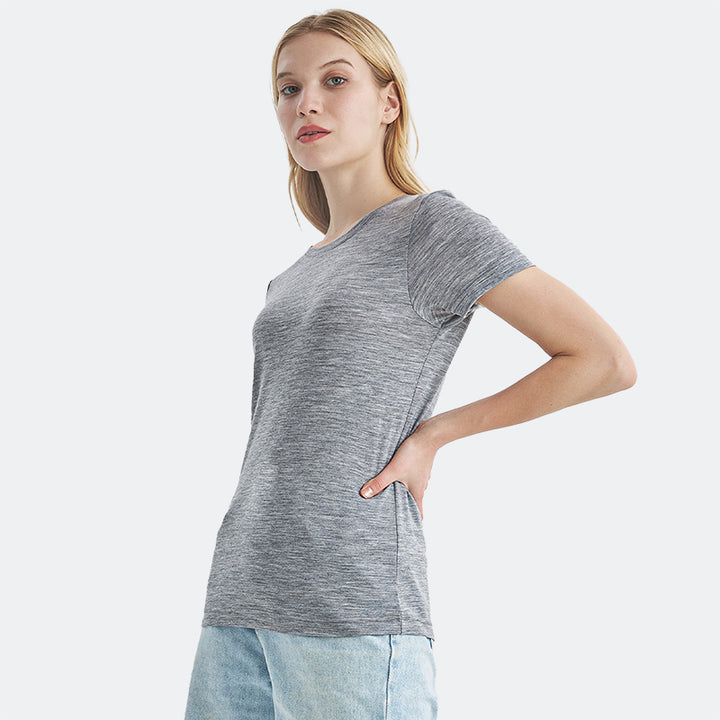 Famel model wearing a lightweight Merino wool short sleeve crew t-shirt, breathable and comfortable, shown in ebony heather.