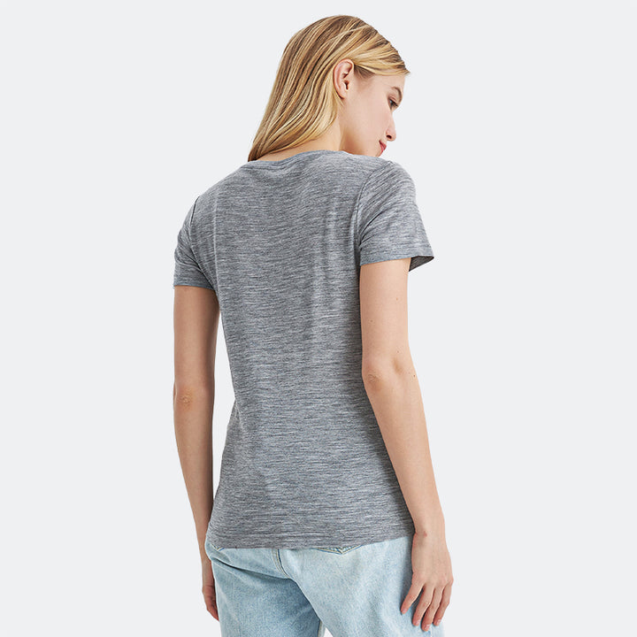 Famel model wearing a lightweight Merino wool short sleeve crew t-shirt, breathable and comfortable, shown in ebony heather.