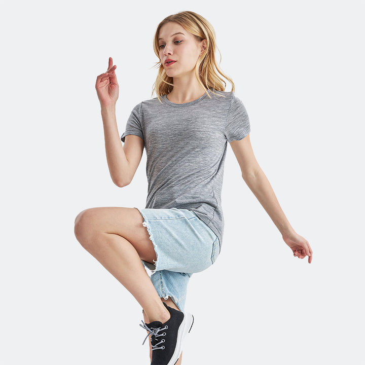 Famel model wearing a lightweight Merino wool short sleeve crew t-shirt, breathable and comfortable, shown in ebony heather.