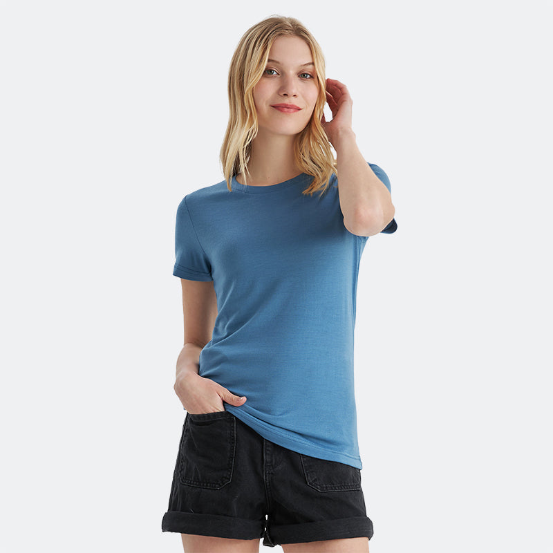 Famel model wearing a lightweight Merino wool short sleeve crew t-shirt, breathable and comfortable, shown in emerald.