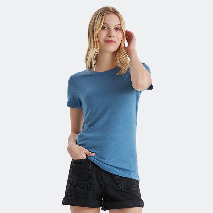 Famel model wearing a lightweight Merino wool short sleeve crew t-shirt, breathable and comfortable, shown in emerald.