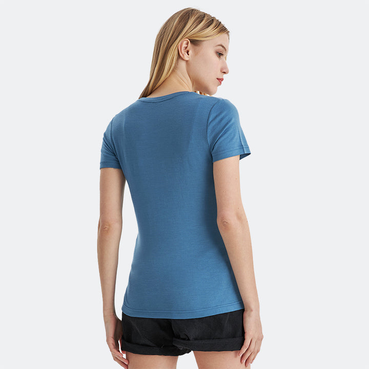 Famel model wearing a lightweight Merino wool short sleeve crew t-shirt, breathable and comfortable, shown in emerald.