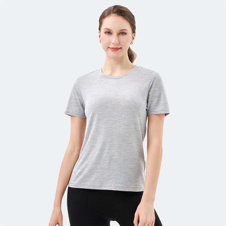 Famel model wearing a lightweight Merino wool short sleeve crew t-shirt, breathable and comfortable, shown in light grey.