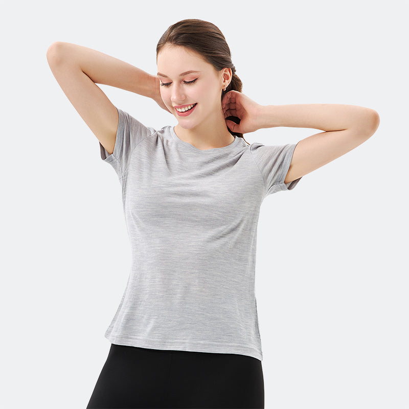 Famel model wearing a lightweight Merino wool short sleeve crew t-shirt, breathable and comfortable, shown in light grey.