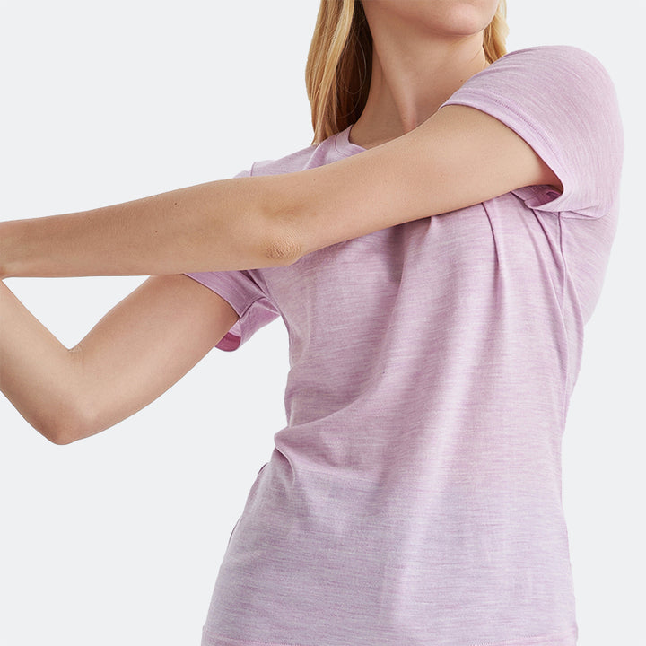 Famel model wearing a lightweight Merino wool short sleeve crew t-shirt, breathable and comfortable, shown in pink heather.