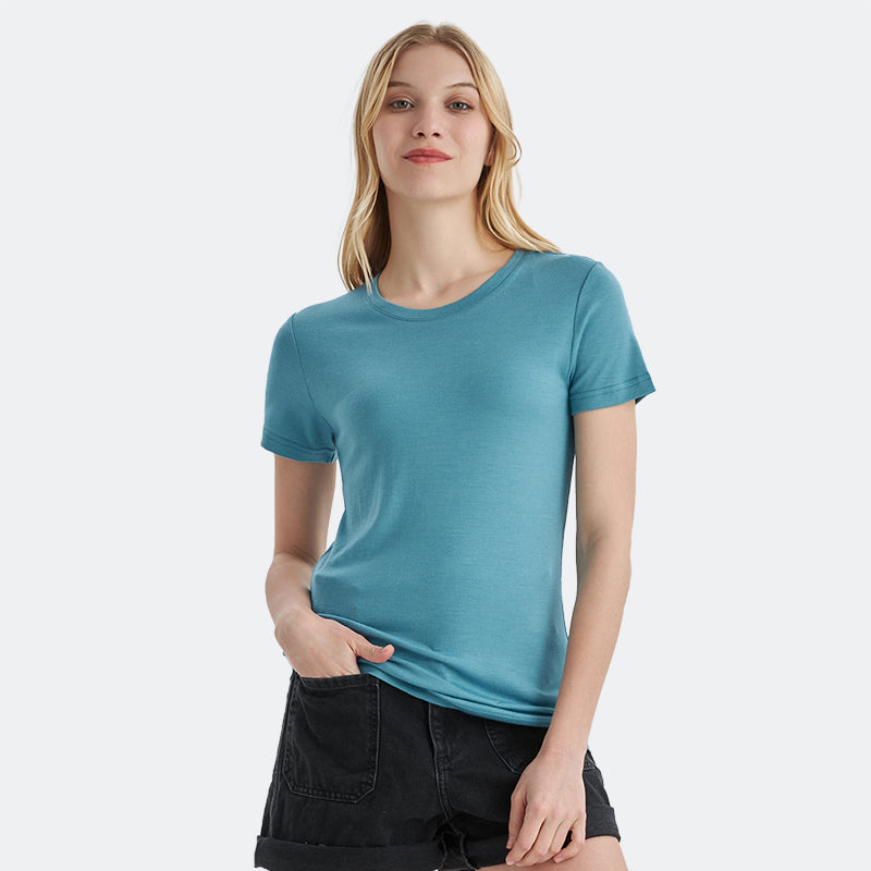 Famel model wearing a lightweight Merino wool short sleeve crew t-shirt, breathable and comfortable, shown in teal.