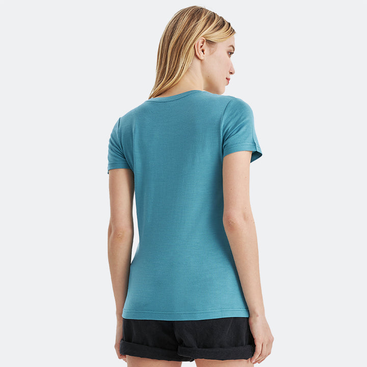 Famel model wearing a lightweight Merino wool short sleeve crew t-shirt, breathable and comfortable, shown in teal.