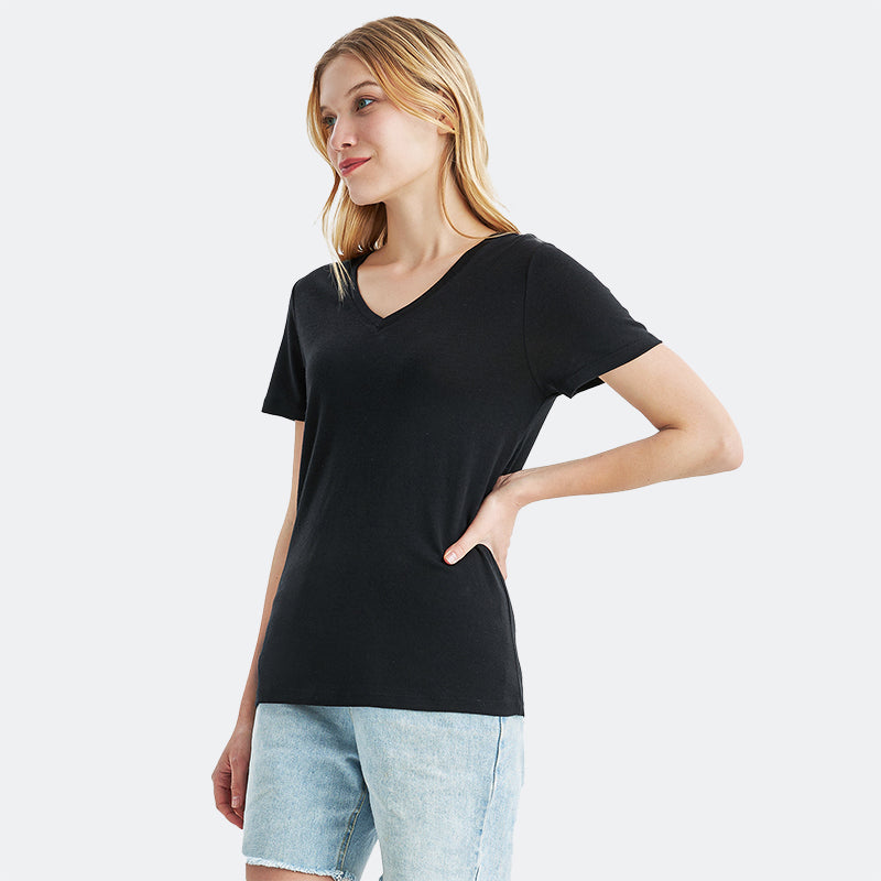 Famel model wearing a lightweight Merino wool short sleeve v-neck t-shirt, breathable and comfortable, shown in Black.