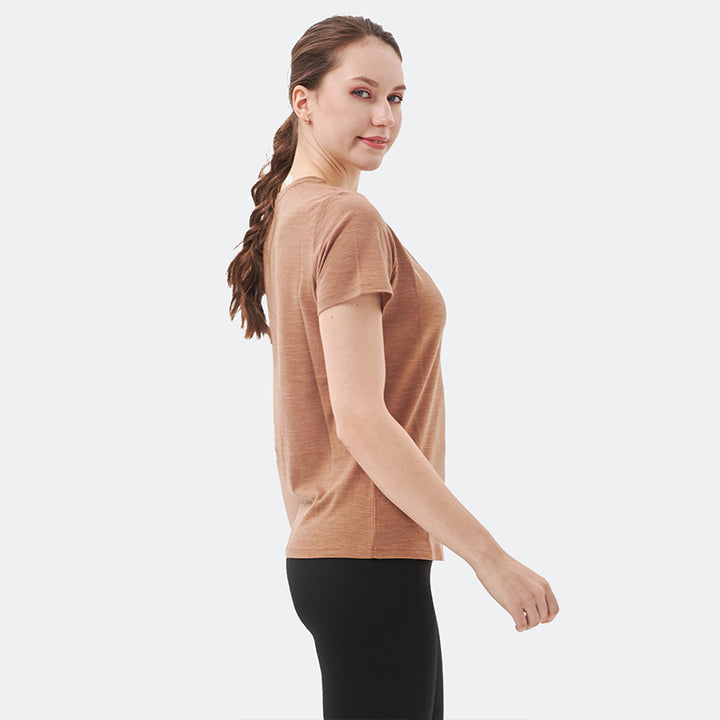 Famel model wearing a lightweight Merino wool short sleeve v-neck t-shirt, breathable and comfortable, shown in Caramel.