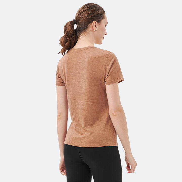 Famel model wearing a lightweight Merino wool short sleeve v-neck t-shirt, breathable and comfortable, shown in Caramel.