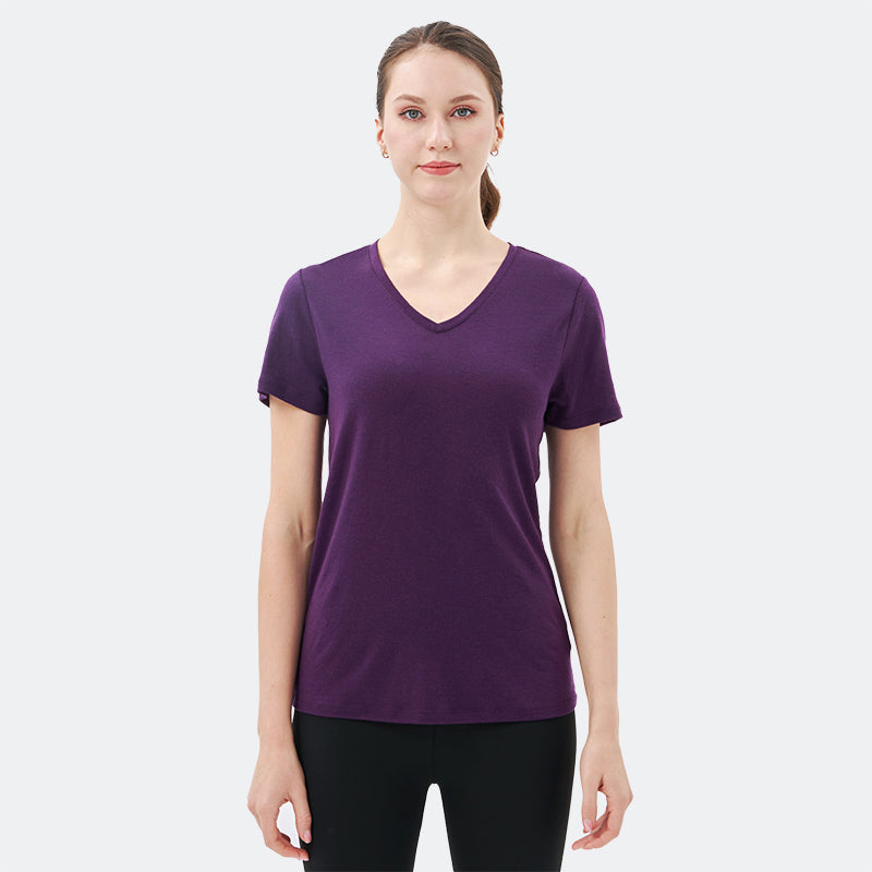 Famel model wearing a lightweight Merino wool short sleeve v-neck t-shirt, breathable and comfortable, shown in Dark Purple.