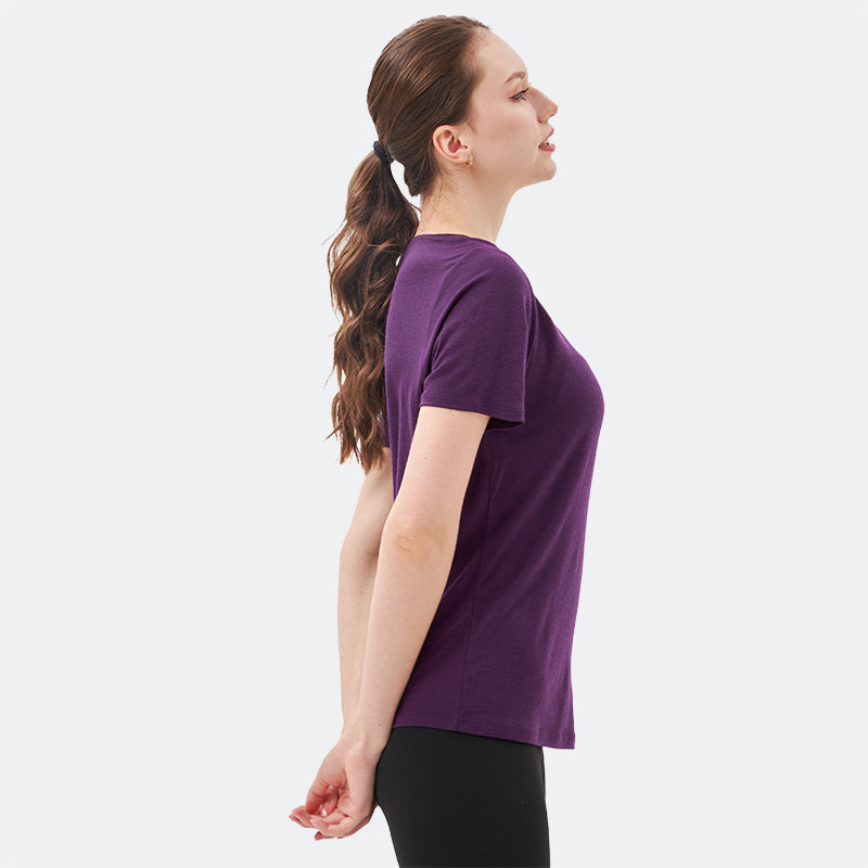Famel model wearing a lightweight Merino wool short sleeve v-neck t-shirt, breathable and comfortable, shown in Dark Purple.