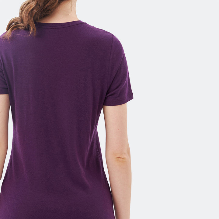 Famel model wearing a lightweight Merino wool short sleeve v-neck t-shirt, breathable and comfortable, shown in Dark Purple.