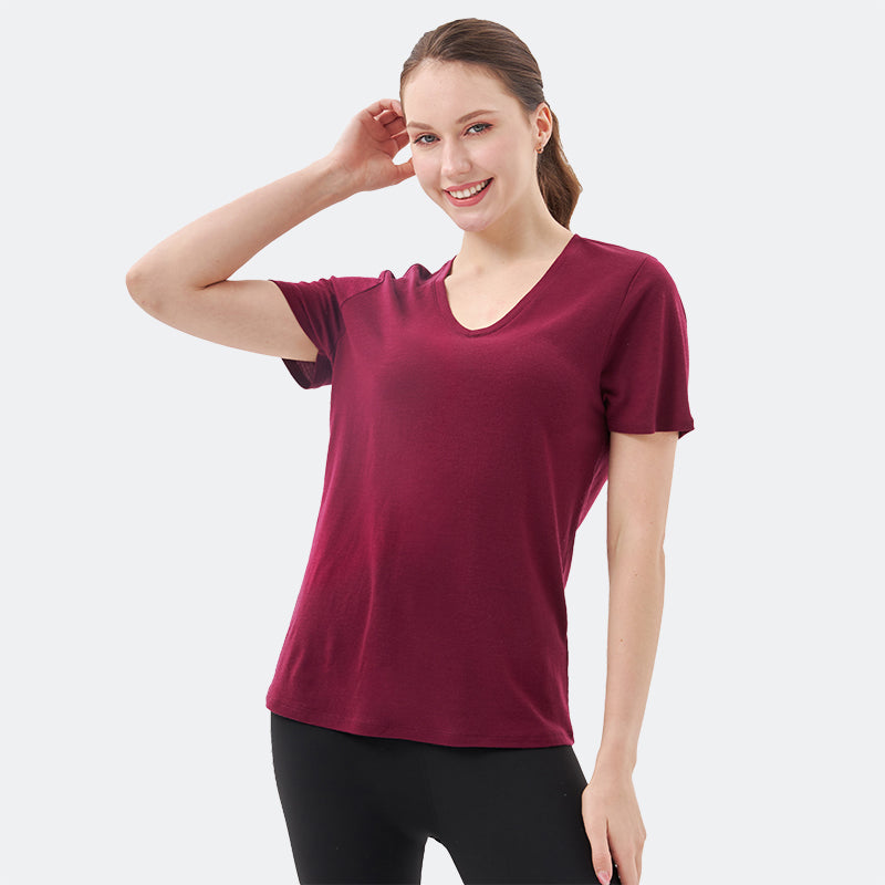 Famel model wearing a lightweight Merino wool short sleeve v-neck t-shirt, breathable and comfortable, shown in Dark Red.