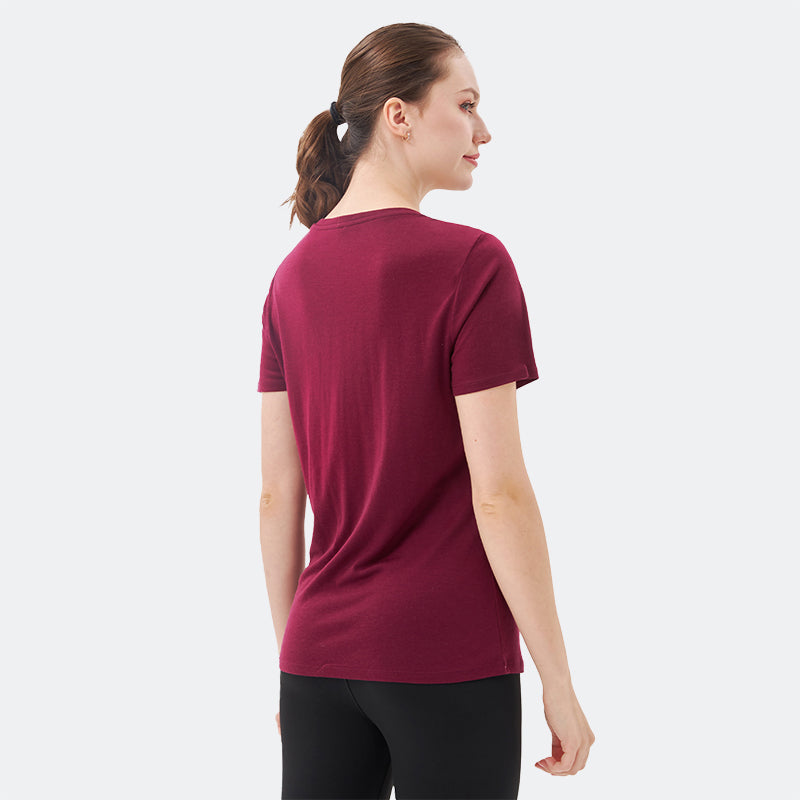 Famel model wearing a lightweight Merino wool short sleeve v-neck t-shirt, breathable and comfortable, shown in Dark Red.