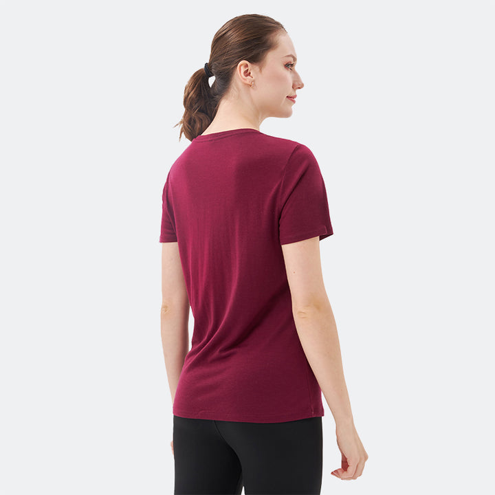 Famel model wearing a lightweight Merino wool short sleeve v-neck t-shirt, breathable and comfortable, shown in Dark Red.
