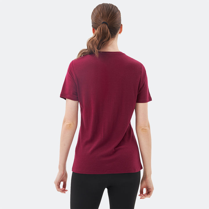 Famel model wearing a lightweight Merino wool short sleeve v-neck t-shirt, breathable and comfortable, shown in Dark Red.