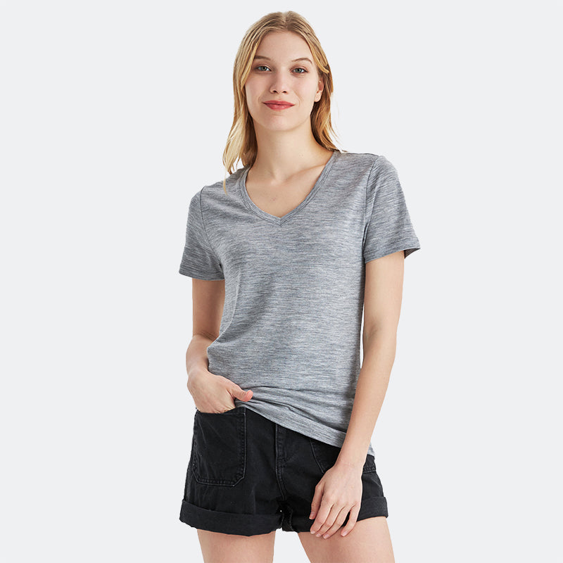 Famel model wearing a lightweight Merino wool short sleeve v-neck t-shirt, breathable and comfortable, shown in Ebony Heather.