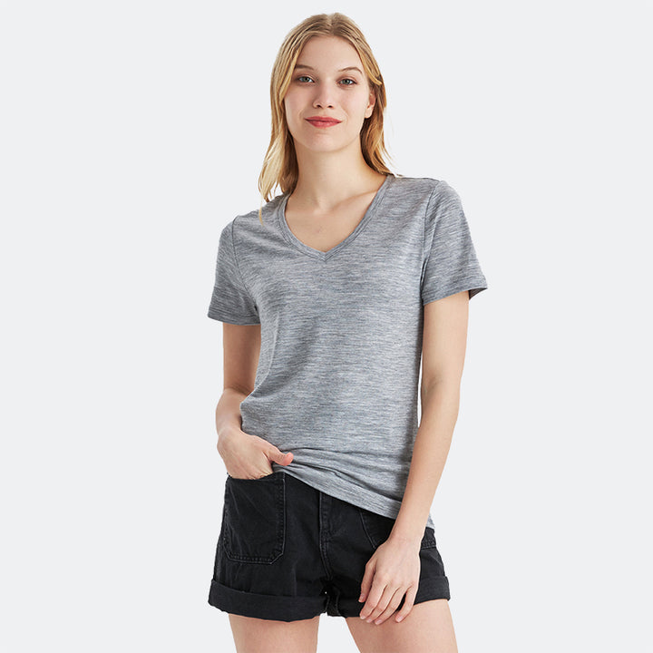 Famel model wearing a lightweight Merino wool short sleeve v-neck t-shirt, breathable and comfortable, shown in Ebony Heather.