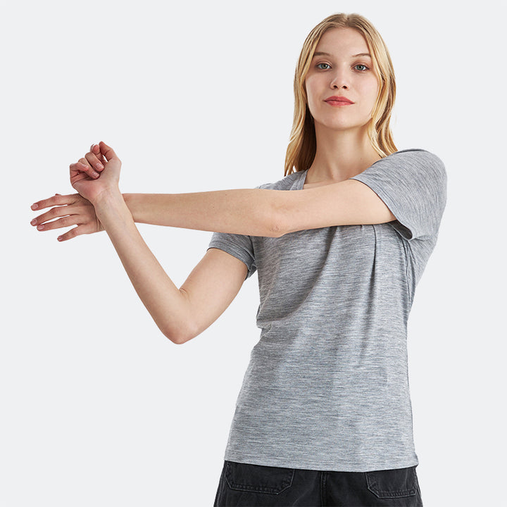 Famel model wearing a lightweight Merino wool short sleeve v-neck t-shirt, breathable and comfortable, shown in Ebony Heather.