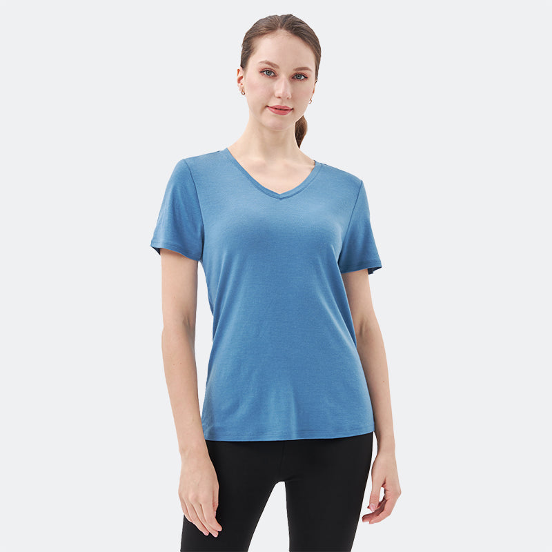 Famel model wearing a lightweight Merino wool short sleeve v-neck t-shirt, breathable and comfortable, shown in Lake blue.