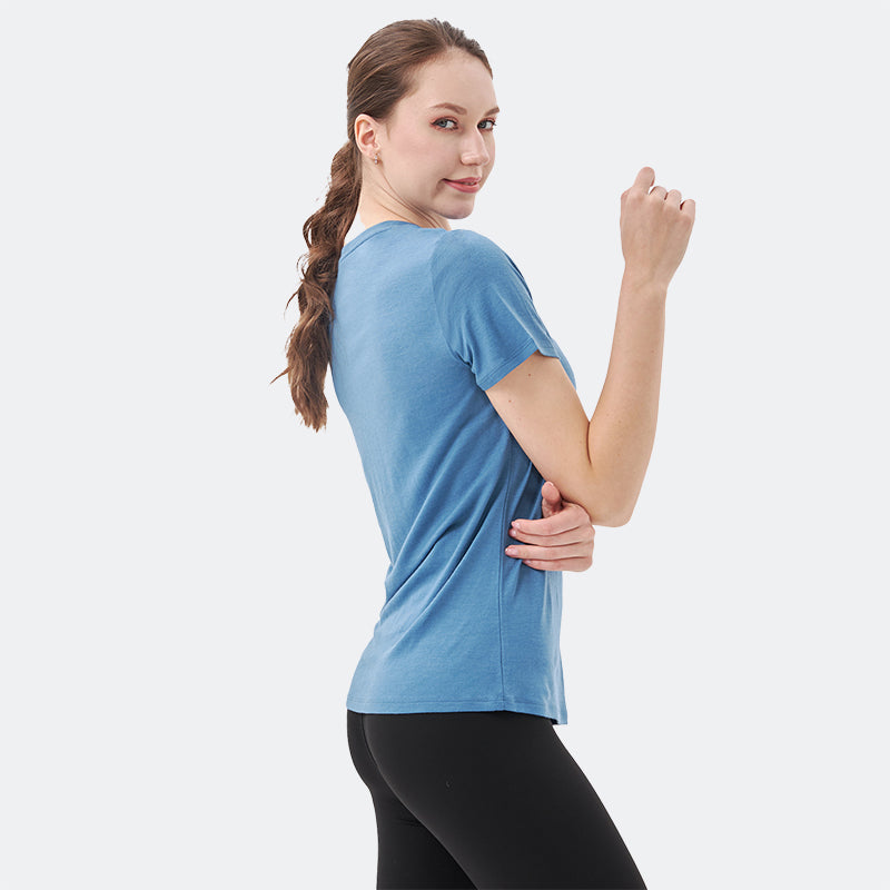 Famel model wearing a lightweight Merino wool short sleeve v-neck t-shirt, breathable and comfortable, shown in Lake blue.