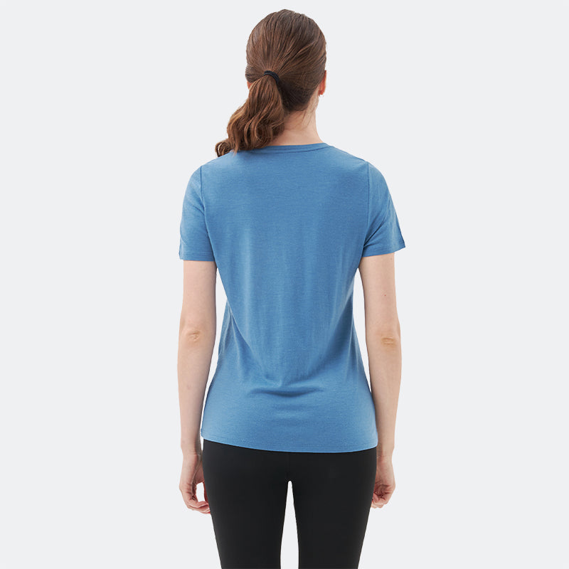 Famel model wearing a lightweight Merino wool short sleeve v-neck t-shirt, breathable and comfortable, shown in Lake blue.