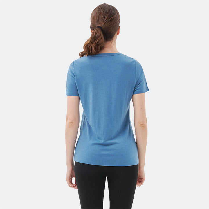 Famel model wearing a lightweight Merino wool short sleeve v-neck t-shirt, breathable and comfortable, shown in Lake blue.