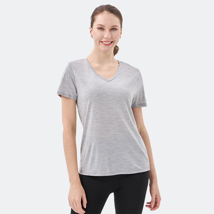 Famel model wearing a lightweight Merino wool short sleeve v-neck t-shirt, breathable and comfortable, shown in Light Grey Heather.