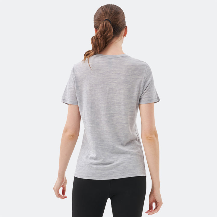Famel model wearing a lightweight Merino wool short sleeve v-neck t-shirt, breathable and comfortable, shown in Light Grey Heather.