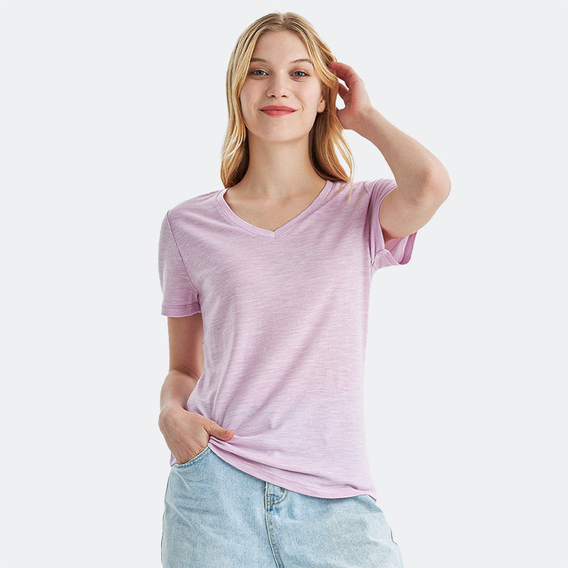 Famel model wearing a lightweight Merino wool short sleeve v-neck t-shirt, breathable and comfortable, shown in Pink Heather.
