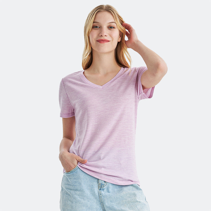 Famel model wearing a lightweight Merino wool short sleeve v-neck t-shirt, breathable and comfortable, shown in Pink Heather.