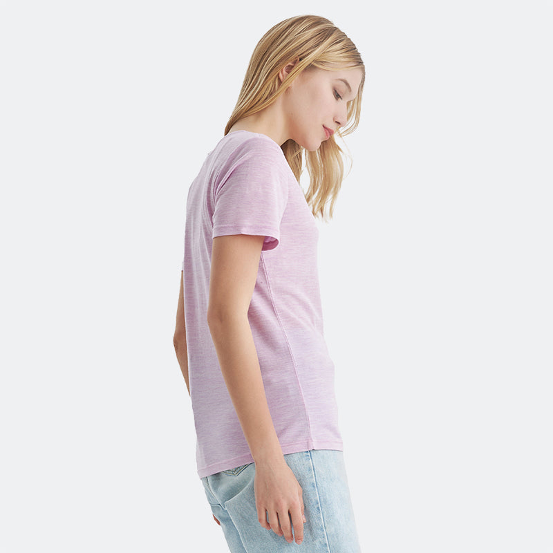 Famel model wearing a lightweight Merino wool short sleeve v-neck t-shirt, breathable and comfortable, shown in Pink Heather.