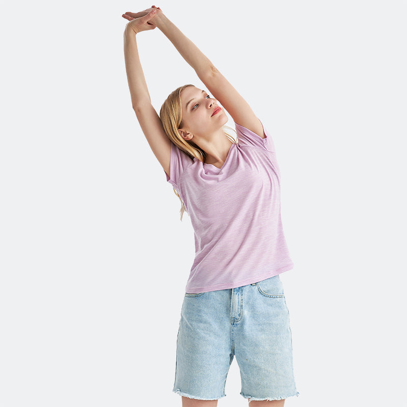 Famel model wearing a lightweight Merino wool short sleeve v-neck t-shirt, breathable and comfortable, shown in Pink Heather.