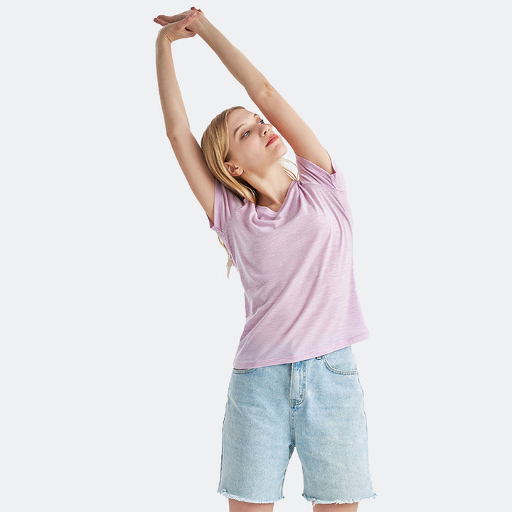 Famel model wearing a lightweight Merino wool short sleeve v-neck t-shirt, breathable and comfortable, shown in Pink Heather.