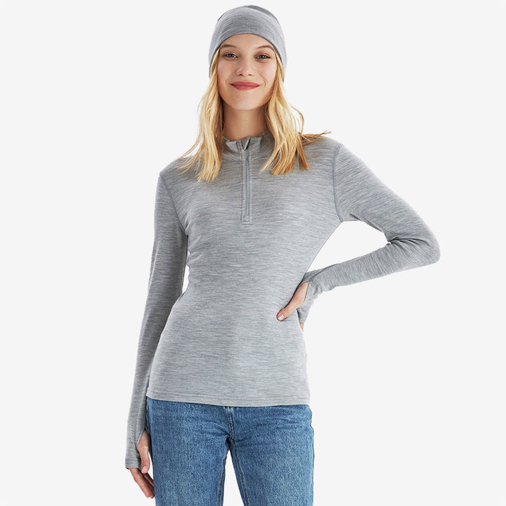 Famel  model wearing Light Grey Heather Men’s 250g Merino wool long sleeve half zip top, breathable and moisture-wicking for warmth and outdoor comfort.