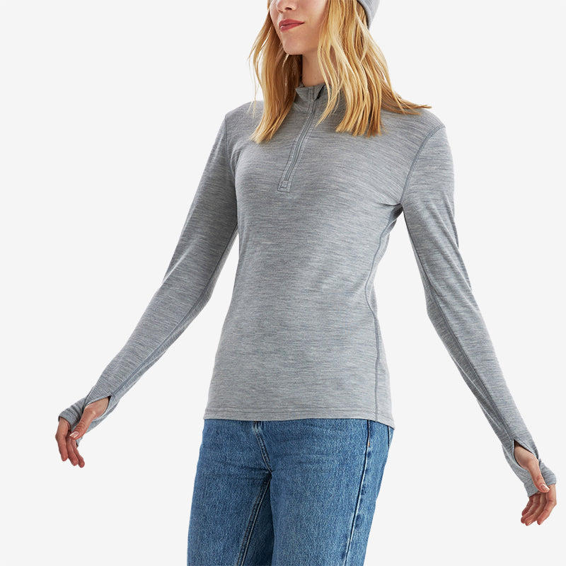 Famel  model wearing Light Grey Heather Men’s 250g Merino wool long sleeve half zip top, breathable and moisture-wicking for warmth and outdoor comfort.