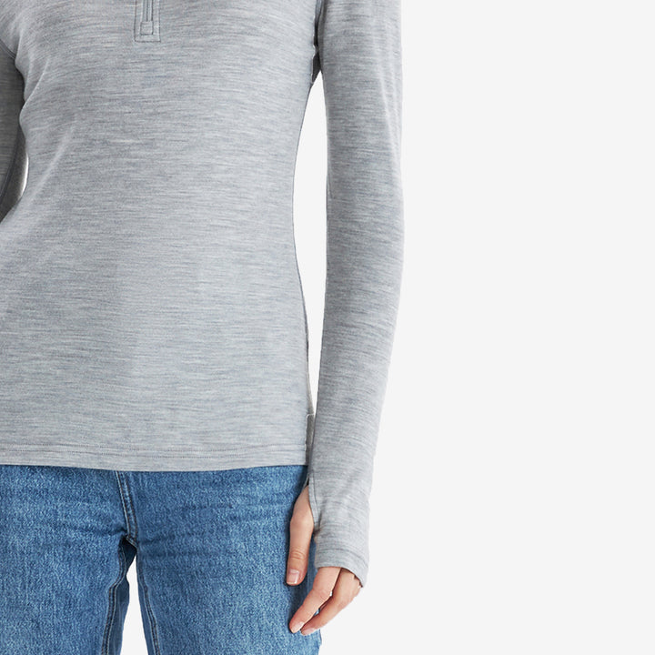 Famel  model wearing Light Grey Heather Men’s 250g Merino wool long sleeve half zip top, breathable and moisture-wicking for warmth and outdoor comfort.